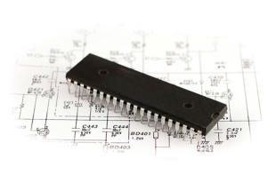photo of computer chip setting on a schematic drawing